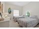 Bedroom with two twin beds, decorative surfboards, and wicker furniture at 5300 S Atlantic Ave # 6-507, New Smyrna Beach, FL 32169