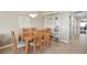 Dining room with wooden table and seating, complemented by a decorative light fixture, and tiled flooring at 5300 S Atlantic Ave # 6-507, New Smyrna Beach, FL 32169