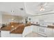 Open kitchen with granite countertops, white cabinetry, appliances, and tile flooring for easy maintenance at 5300 S Atlantic Ave # 6-507, New Smyrna Beach, FL 32169