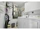 Functional laundry room with white washer, dryer and storage cabinets at 5300 S Atlantic Ave # 6-507, New Smyrna Beach, FL 32169