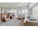 Open-concept living space with tile floors, neutral furniture, and balcony access at 5300 S Atlantic Ave # 6-507, New Smyrna Beach, FL 32169