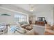 Bright living room featuring comfortable furniture, tile floors, and a view of the balcony at 5300 S Atlantic Ave # 6-507, New Smyrna Beach, FL 32169