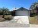 Home featuring an attached two-car garage and a spacious driveway for ample parking at 549 Silvergate Loop, Lake Mary, FL 32746