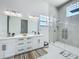 Bright bathroom featuring double vanity, modern fixtures, and frameless glass shower at 601 Green Briar Blvd, Altamonte Springs, FL 32714