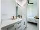 Bathroom features a modern white vanity, a sink, and is adjacent to the bedroom at 601 Green Briar Blvd, Altamonte Springs, FL 32714