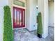 Elegant front entry featuring a modern door, decorative plants, and gray stone tile at 601 Green Briar Blvd, Altamonte Springs, FL 32714