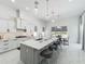 Open-concept kitchen with a large center island, gray cabinets, pendant lighting, and seamless integration with the dining area at 601 Green Briar Blvd, Altamonte Springs, FL 32714