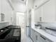 Clean, organized laundry room featuring upper cabinets, sleek appliances, and marble floor at 601 Green Briar Blvd, Altamonte Springs, FL 32714