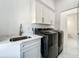 Well-equipped laundry room with modern appliances, custom cabinets, and marble countertops at 601 Green Briar Blvd, Altamonte Springs, FL 32714