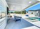 The outdoor entertainment area features a covered space with a TV and game table next to a pool and hot tub at 601 Green Briar Blvd, Altamonte Springs, FL 32714