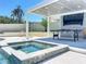 An outdoor entertainment area, complete with a ping pong table and TV, is adjacent to the pool and hot tub at 601 Green Briar Blvd, Altamonte Springs, FL 32714