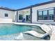 A luxurious pool with a sun shelf and lounge chairs provides a relaxing retreat off the back of the home at 601 Green Briar Blvd, Altamonte Springs, FL 32714