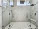 Elegant dual shower with marble tile, frameless glass doors, and built-in bench at 601 Green Briar Blvd, Altamonte Springs, FL 32714