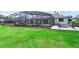 Expansive backyard featuring lush green grass, a screened-in pool, and an outdoor fire pit area at 633 N Longview Pl, Longwood, FL 32779
