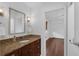 Bathroom with granite counters, updated fixtures, and view to bedroom at 633 N Longview Pl, Longwood, FL 32779