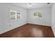 Empty bedroom with hardwood floors and two windows at 633 N Longview Pl, Longwood, FL 32779