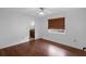 Empty bedroom with hardwood floors, a window, and a connecting bathroom at 633 N Longview Pl, Longwood, FL 32779