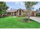 Charming brick home featuring a well-manicured lawn and mature landscaping, creating excellent curb appeal at 633 N Longview Pl, Longwood, FL 32779