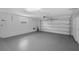 Spacious garage with epoxy flooring and ample storage and work area, and an automatic door at 633 N Longview Pl, Longwood, FL 32779
