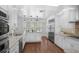 Well-lit kitchen featuring white cabinetry, stainless steel appliances, and an eat-in island at 633 N Longview Pl, Longwood, FL 32779