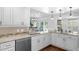 Well-equipped kitchen with granite countertops, stainless steel appliances, white cabinets and seamless access to the breakfast nook at 633 N Longview Pl, Longwood, FL 32779