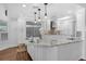 Modern kitchen featuring white cabinets, stainless steel appliances, granite countertops, and a breakfast bar at 633 N Longview Pl, Longwood, FL 32779