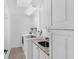 Laundry room featuring a sink, granite countertop, storage cabinets, and washer and dryer at 633 N Longview Pl, Longwood, FL 32779