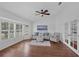 Cozy living room with hardwood floors, many windows with natural light, and neutral decor at 633 N Longview Pl, Longwood, FL 32779