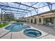Screened-in pool and spa area with outdoor seating and lush landscaping, and ample deck area at 633 N Longview Pl, Longwood, FL 32779