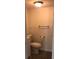 Bathroom featuring a toilet, vanity with white cabinetry, and modern fixtures, with neutral paint and wood look flooring at 647 Madison Ave, Daytona Beach, FL 32114