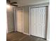 Bedroom featuring wood look flooring, neutral colored walls, a ceiling fan, and closets at 647 Madison Ave, Daytona Beach, FL 32114
