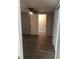 Bedroom with wood look flooring and neutral colored walls; features a closet, ceiling fan, and a doorway leading into a bathroom at 647 Madison Ave, Daytona Beach, FL 32114