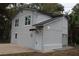 Charming two-story home featuring a fresh gray paint scheme and well-maintained landscaping at 647 Madison Ave, Daytona Beach, FL 32114
