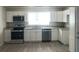 Bright kitchen with stainless steel appliances, white cabinets, and granite countertops, offering a modern and clean aesthetic at 647 Madison Ave, Daytona Beach, FL 32114