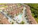 Townhouse community with a pool and a recreation center amongst landscaped grounds at 7572 Sunny Dreams Ln, Kissimmee, FL 34747