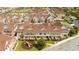 Aerial view shows the townhouses with a playground and meticulous landscaping at 7572 Sunny Dreams Ln, Kissimmee, FL 34747