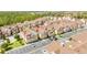Aerial view of colorful townhouse community featuring mature landscaping, and ample parking at 7572 Sunny Dreams Ln, Kissimmee, FL 34747