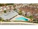 Stunning aerial view of a community pool and well-maintained buildings with lush landscaping at 7572 Sunny Dreams Ln, Kissimmee, FL 34747