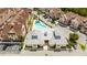 Aerial view of a community pool and recreation center amongst the townhouses at 7572 Sunny Dreams Ln, Kissimmee, FL 34747