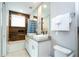 A bathroom featuring dual sinks, granite counters, and a shower/tub combination at 7572 Sunny Dreams Ln, Kissimmee, FL 34747