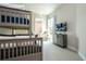 A charming bedroom featuring a bunk bed, a window with natural light, and a TV for entertainment at 7572 Sunny Dreams Ln, Kissimmee, FL 34747