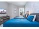 Bright bedroom featuring two beds, grey accent wall, modern decor, and a flat screen TV at 7572 Sunny Dreams Ln, Kissimmee, FL 34747