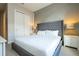 This bedroom has a queen-sized bed with a plush gray upholstered headboard and bedside tables at 7572 Sunny Dreams Ln, Kissimmee, FL 34747
