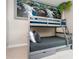 The bedroom has a bunk bed with gray trim and a decorative mural behind it at 7572 Sunny Dreams Ln, Kissimmee, FL 34747