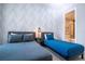 Guest bedroom with modern decor, two beds, and patterned accent wall at 7572 Sunny Dreams Ln, Kissimmee, FL 34747