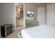 This bedroom boasts a dresser, minibar, television, and ensuite bathroom at 7572 Sunny Dreams Ln, Kissimmee, FL 34747