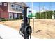Electric vehicle charging station on a sunny day with modern apartments in the background at 7572 Sunny Dreams Ln, Kissimmee, FL 34747