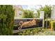 Close up of the community entrance sign, beautifully landscaped with manicured plants and flowers at 7572 Sunny Dreams Ln, Kissimmee, FL 34747