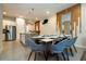 Dining area open to the kitchen featuring modern decor, and table set for meal at 7572 Sunny Dreams Ln, Kissimmee, FL 34747