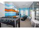 Bright community game room featuring a foosball table, gaming chairs, and play area at 7572 Sunny Dreams Ln, Kissimmee, FL 34747